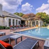 a swimming pool in front of a brick building