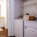 side-by-side washer and dryer in laundry space next to bathroom