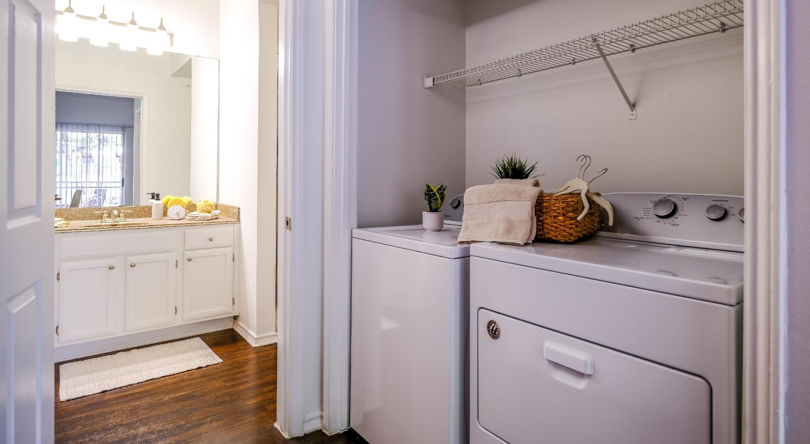 We've got your laundry sorted side-by-side washer and dryer in laundry space next to bathroom