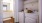 side-by-side washer and dryer in laundry space next to bathroom