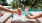 a couple of drinks on a poolside table