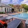 a swimming pool with chairs and tables nearby