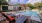 a swimming pool with chairs and tables nearby