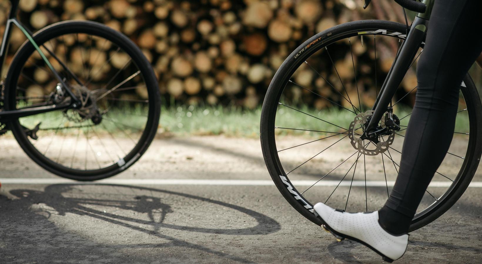 Get your workout on people walking their bicycles down the road