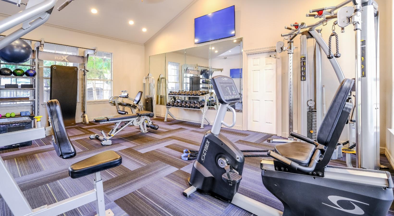 State-of-the-art amenities a gym with exercise equipment