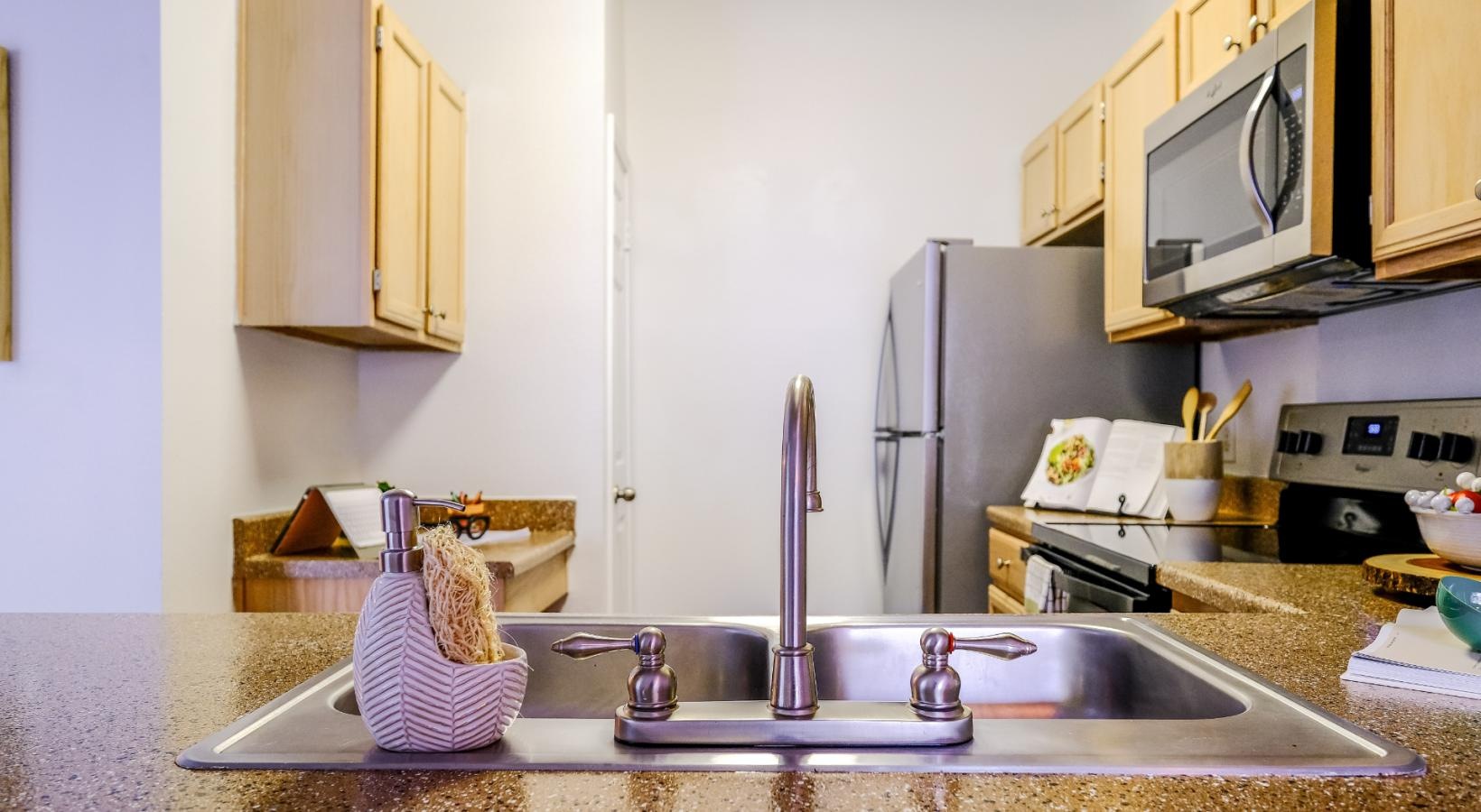 Spacious kitchens with thoughtful details a kitchen with a stainless steel sink