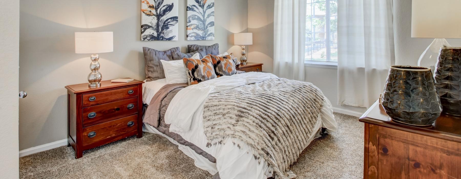 a bedroom with a bed and lamps