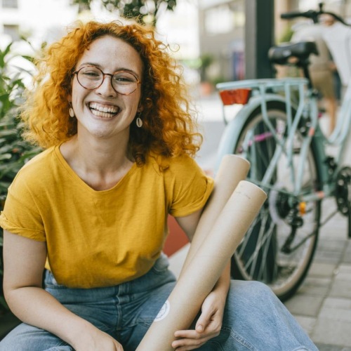 a person sitting on a sidewalk